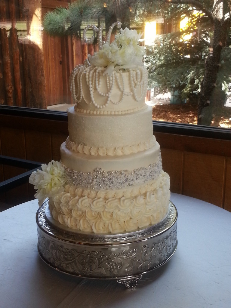 4 Tire Round Wedding Cake Decorated With Sugar Pearls Silver Dragees Sparkle Sugar And Rosettes