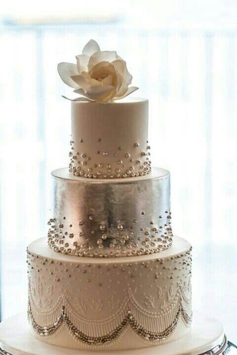 Classic white wedding cake with a metallic silver middle tier